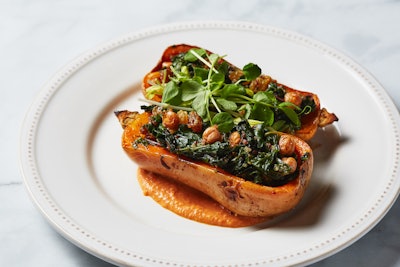 The vegetarian entree is stuffed honeynut squash with piquillo pepper hummus, braised rainbow chard, crispy chickpeas, quinoa, golden raisins, and sunflower sprouts.