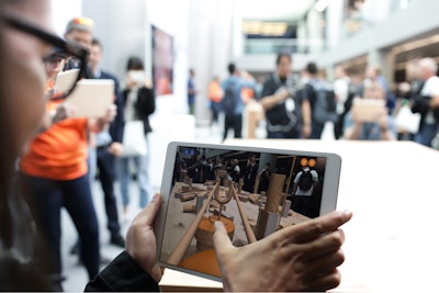 An attendee at Apple’s Worldwide Developers Conference (WWDC), which took place June 4 to 8 in San Jose, California, tested out the game SwiftShot in the AR game room.