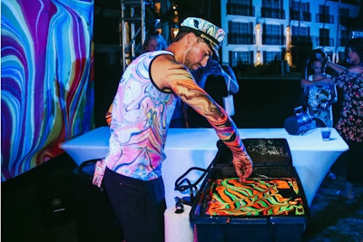 During the “Mad Hatter” after-party, guests were able to get psychedelic hand and arm marbling from Black Light Visuals.