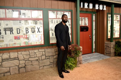 Actor Trevante Rhodes posed in front of a step-and-repeat inspired by the film's safe house. Newspapers covering the windows were a nod to another survival tactic from the film.