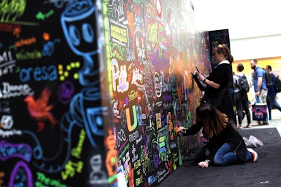 Adobe Max attendees were invited to sign and decorate an oversize chalkboard.