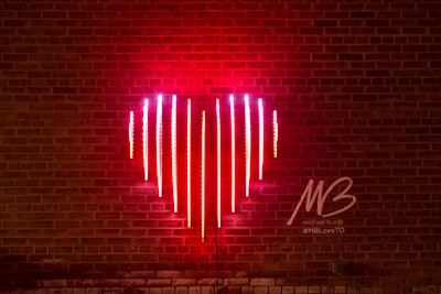 Michael Bublé’s Edge Lit Heart is a kinetic light sculpture inspired by Canadian singer's album Love (stylized as the red heart emoji). The sculpture incorporates hundreds of animated LEDs to light eleven acrylic panels. Toronto-based visual artist Craig Small created the sculpture.