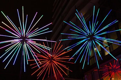 The Electric Dandelions, created by U.S.-based artist Abram Santa Cruz, are three 27-foot-tall dandelion sculptures that resemble fireworks at night with LED animations. The sculptures are composed of geometrically designed metal and acrylic.
