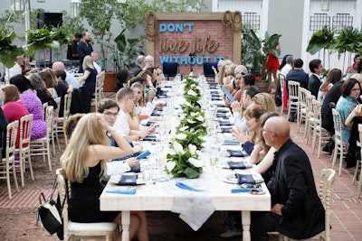 Card members were treated to a Dine Small pre-show dinner curated by chef José Andrés. The tented dinner space at La Arcada featured a brick wall adorned with decor promoting American Express’ marketing campaign.