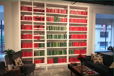 To introduce media to its holiday offerings, Amazon hosted a festive preview event in New York in August. The design from Shiraz Creative took guests into various parts of a home, including a posh library. A nearly ceiling-height set of bookshelves contained books painted in red and green to create a Christmas tree.