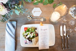 Blue Plate is putting a unique twist on the traditional bread service for seated dinners. At each setting, the evening's menu is printed on a bread sleeve containing an individual baguette. A trio of butters—including flavors like garlic and herb, honey pecan, and goat’s milk—is placed on the table and served family style for everyone to share.