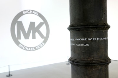 The visceral experience allowed guests to experience a multitude of vignettes throughout the expansive space. While the Kors logo was liberally expressed throughout the venue, the event's hashtag was stenciled on the cast iron building's existing columns in a streetscape style.