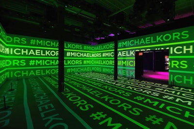 As guests walked in, they entered the Infinity Space: a 360-projected environment featuring bright, graphic treatments of the Michael Kors charm displayed on an infinite wall of Dolby Vision-enabled televisions. The room alternated a series of logo-laden video images akin to a nightclub for a truly immersive and interactive experience while guests could capture their experiences via Hypno BODY cameras.
