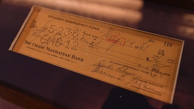 Guests hold original artifacts that relate to tour stories, including this check from Jackie Robinson
