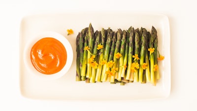 A simple dish gently elevated – Poached Asparagus with Romesco Sauce and Micro Marigolds.