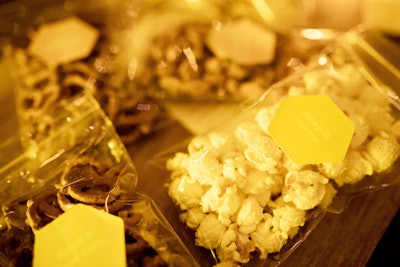 To-go treats such as popcorn and pretzels were on hand for guests. Bags were labeled with yellow taglines, including ones that read 'Keep it Corny.'