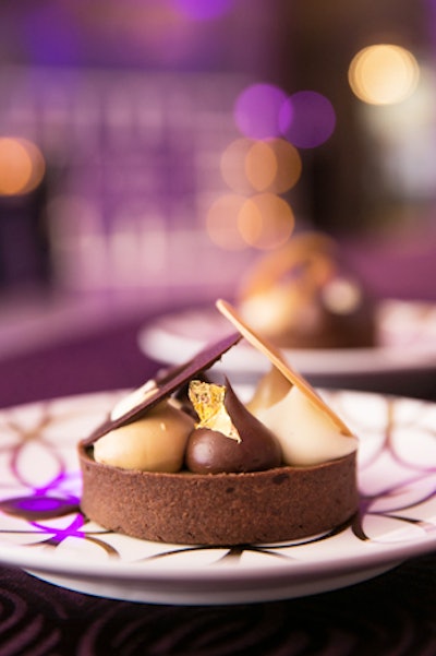 Chocolate tart filled with cocoa nibs, soft caramel, and coffee ganache, and topped with mocha whipped ganache and a disc of Dulcey chocolate, by Ridgewells Catering in Bethesda, Maryland