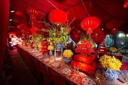 Eddie Zaratsian created lush red and yellow floral designs inside the dinner tent.