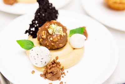 A chocolate rocher served with coffee chantilly, cake tuile, and chicory meringue, topped with gold leaf, by Patina Catering in Los Angeles