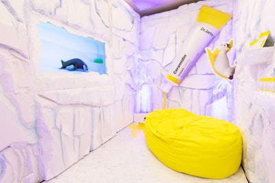 At the Sephora conference, the booth promoting Dr. Jart’s Ceramidin Cream, a moisture barrier detector, featured an Antarctic theme with penguin cut-outs, a yellow bean bag, and a giant replica of the product.