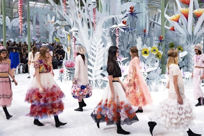 In January 2015, the Chanel haute couture show featured a gigantic circular white garden installed beneath the dome of the Grand Palais in Paris. It took six months to make the 300 flowers that decorated the set. Each flower had its own 'engine' and burst into full technicolor mechanical bloom after one of the models “watered” them from a CC-branded watering can.