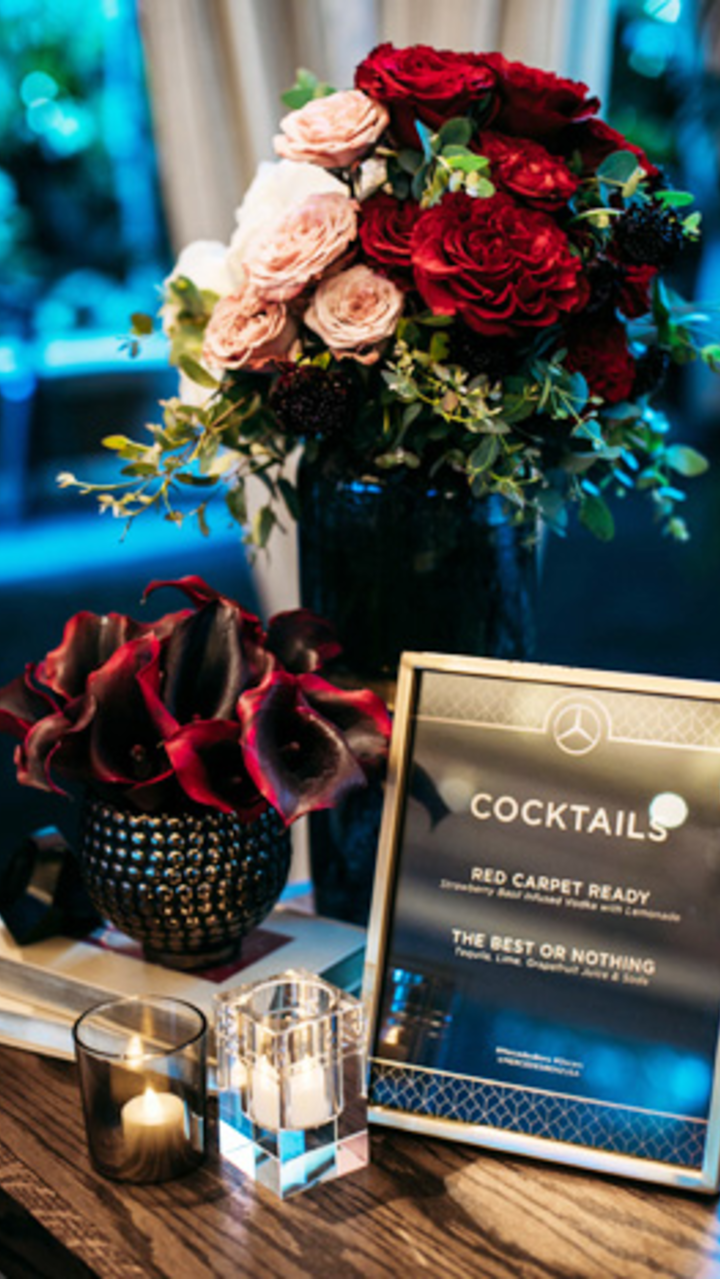 For Mercedes-Benz USA's annual Oscars viewing party, event designers Sterling Social also used a deep red color scheme for florals and rentals. Vases were placed on top of books, creating a cozy, residential feel.
