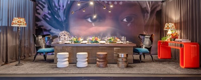 The setting by the Black Artists & Designers Guild, a collective of artists creating art, home furnishings, and interior and exterior spaces, was dominated by a giant backdrop featuring the face of an African woman.
