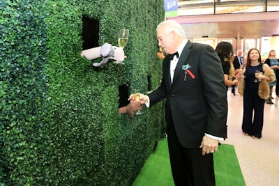 In a fun twist on a champagne wall, servers wearing sock puppets offered glasses to guests from behind green hedging. The puppets were custom-designed by Melissa Leitch of Puppetude.