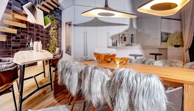 Interior designer Lucinda Loya combined her passion for dining and entertaining with this vignette. In partnership with German Kitchen Center and Luceplan, Loya set out gray, shaggy dining chairs against a forced perspective backdrop that gave the illusion of a much larger space.