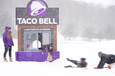 From a 'slide-thru' window, Taco Bell ambassadors handed out Cheetos Crunchwrap Sliders to consumers who tubed down a hill.