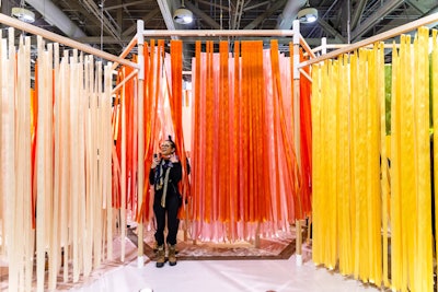 Dutch designer Marije Vogelzang, who specializes in working with food, partnered with kitchen countertop company Caesarstone to debut 'Seeds' at the Interior Design Show. This was the first installment of Vogelzang and Caesarstone's 2019 collaboration. The interactive installation took viewers through the life cycle of a seed from inception to menu ingredient, with different stations surrounded by colorful ribbons.