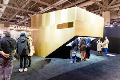 Arc & Co. designed a futuristic booth for Wynn Audio, meant to resemble a modern gramophone. The gold booth required visitors to venture in by ducking under the entrance to block out the outside world, allowing them to focus on a wall of sound coming from Wynn Audio's high-end speakers.
