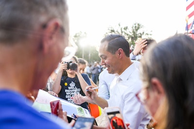 Presidential candidate Julian Castro signs memorabilia after speaking at rally in San Antonio, TX