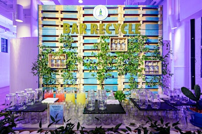 Another wall of wooden pallets was located behind the bar, with green moss used to spell the name of the event and shelves holding Absolut bottles.
