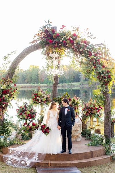 'For a wedding, it is important to have an amazing backdrop behind the couple. For this wedding with Suzanne Reinhard Events, the background of the lake and the forest was already a million-dollar shot, so I wanted to create a backdrop statement that looked as if it had grown there. The trees that make the arch are actually fake, but made to look real. The flowers are also incredible, and the crystal chandelier just tips the scale to give the altar a little sparkle for the wedding. For this wedding, we also built a 350-foot walkway with arches every 25 feet covered in flowers, just to make a statement.' —Brian Worley, independent event designer, Atlanta