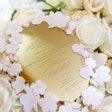 For a private wedding, held at the National Museum of Women in the Arts in Washington in March 2018, Favored by Yodit Events & Design and By Dami Studios created golden menus with cherry blossom frames to mimic the event’s theme.