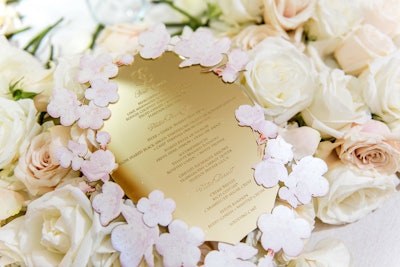 For a private wedding, held at the National Museum of Women in the Arts in Washington in March 2018, Favored by Yodit Events & Design and By Dami Studios created golden menus with cherry blossom frames to mimic the event’s theme.