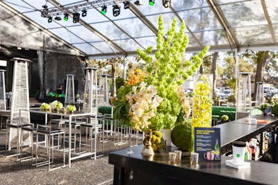 EPI designed large floral displays in shades of green and white with pops of orange.