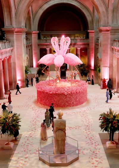 The floral centerpiece featured five 25-foot-tall flamingo statues with pink faux feathers and gold sequins and glitter covering their legs and beaks.