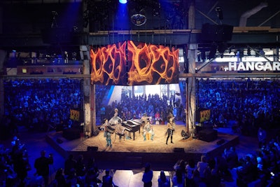 The Agora space provided one of the main stages for speakers and performances, including an opening night show by Cirque du Soleil. The hexagonal, 360-degree stage was covered in sand, which C2 president Richard St-Pierre said was a nod to the conference's commitment to sustainability. Efforts to reduce the conference's carbon footprint included providing recyclable attendee badges, banning straws and single-use water bottles on site, and reducing the proportion of fossil fuel-powered machines used in the buildout to below 40 percent. Another section of the space also held the 'Braindate Lounge,' where attendees had one-on-one conversations on specific topics.