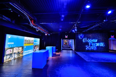 Another space featured a digital wall with imagery and hashtags highlighting important current and upcoming events. Additional decor included a hashtag sign of the event in bold, blue-lighted block letters.