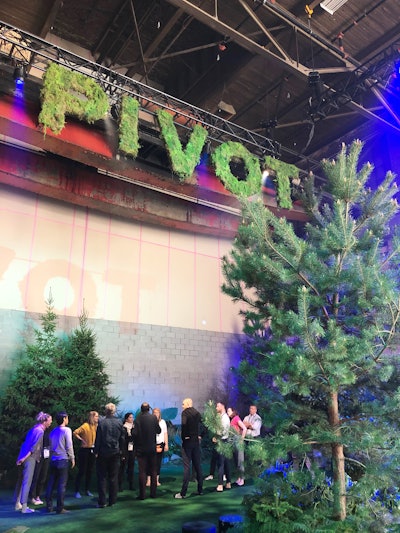 One of six conference labs was Pivot, which invited attendees to learn about body mechanics and how understanding them can deepen trust in teams. Participants worked with professional dancers for the lab, held in a forest-theme environment with real trees.