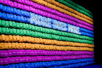 The entrance featured a tunnel of 7,000 backpacks arranged in colorful rows. The backpacks were filled with school supplies and donated following the event.