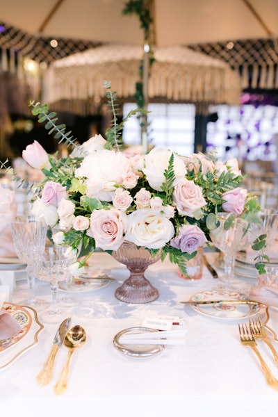 Lovesome Blossom Floral Design completed the look with a live hedge wall and a giant greenery chandelier, as well as floral centerpieces. Linens came from La Tavola Fine Linen, while Heidi Davidson Design handled calligraphy.
