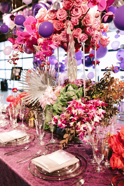 Los Angeles Floral Couture also designed the purple and deep red floral centerpieces, while BBJ Linen provided a patterned tablecloth in similar jewel tones. For the place settings, Brown and Co. handled calligraphy and paper goods.