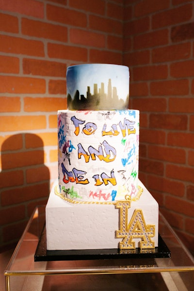 Another 1990s-style design came from Anything But Gray Events for the Wedding International Professionals Association's annual design challenge, held in Los Angeles on May 8. Sugar Studio created a graffiti-inspired cake with the Los Angeles skyline on the top tier and a brick-wall texture on the middle tier. Read more: Time Travel: See How Six Wedding Designers Recreated Six Distinct Decades