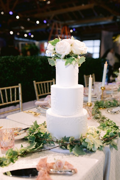 As part of the design, the company's bridal stylist created a modern take on Jackie Kennedy's wedding gown; Brill also incorporated aspects of her husband's grandparents' wedding, such as their own vintage wedding cake server. For Your Party created custom matchbooks, while Vanilla Bake Shop provided a cake.