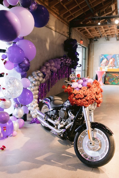 A flower- and balloon-covered Harley-Davidson motorcycle from Los Angeles Harley-Davidson further evoked the Purple Rain album cover.