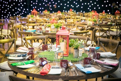 A room called Forever Young had a camp theme, with lantern centerpieces, bandana-style napkins, and a starry night backdrop.