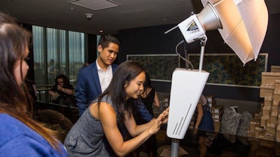 Guests share their photos via email and text during a rooftop party at The Hepburn DC grand opening celebration created by The Brand Guild.