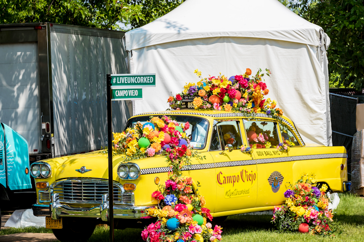 Spanish wine brand Campo Viejo celebrated its Live Uncorked campaign with a station that featured a vintage New York taxi cab overflowing with colorful flowers. Street sign props displayed the campaign hashtag. IMG Live, a division of Endeavor Global Marketing, produced the activation and B Floral created the flower bomb display.