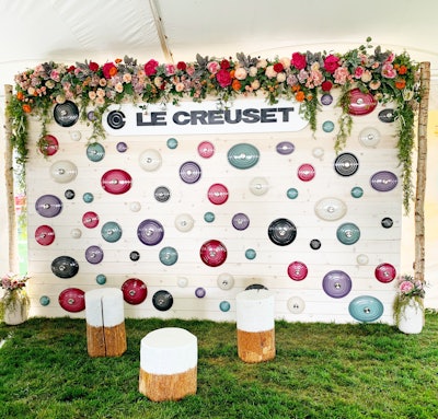 Official cookware sponsor Le Creuset invited guests at the Grand Tasting to pose in front of a floral-topped photo backdrop studded with Le Creuset lids.