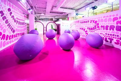 After walking through the tunnels, one of the first tasting stations is a room with white walls, painted with names of wine grapes. Oversize, inflatable “grape” balls add to the atmosphere.