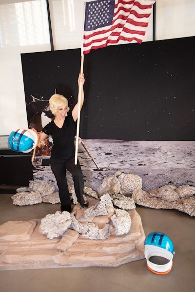 The next station was a GIF booth that invited guests to pose as if they were on the moon. The experience captured participants planting the American flag into moon rock props. A distressed filter produced a GIF inspired by Neil Armstrong and Buzz Aldrin’s first steps. At a separate station, guests could get Twiggy-inspired makeup, wigs, and other accessories for photo ops.