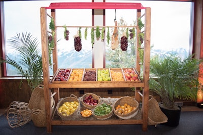 The Wines From Spain Top of the Mountain Party incorporated Spanish-theme market cart decor with fresh produce and hanging meats.